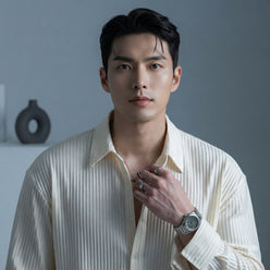 Chris Henderson wearing a white textured popcorn fabric slim-fit shirt against a clean slate gray studio background.